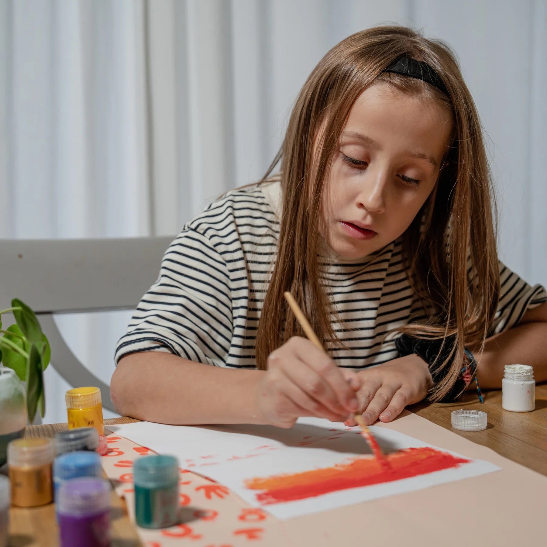 A girl painting with her Sculpd kids canvas kit